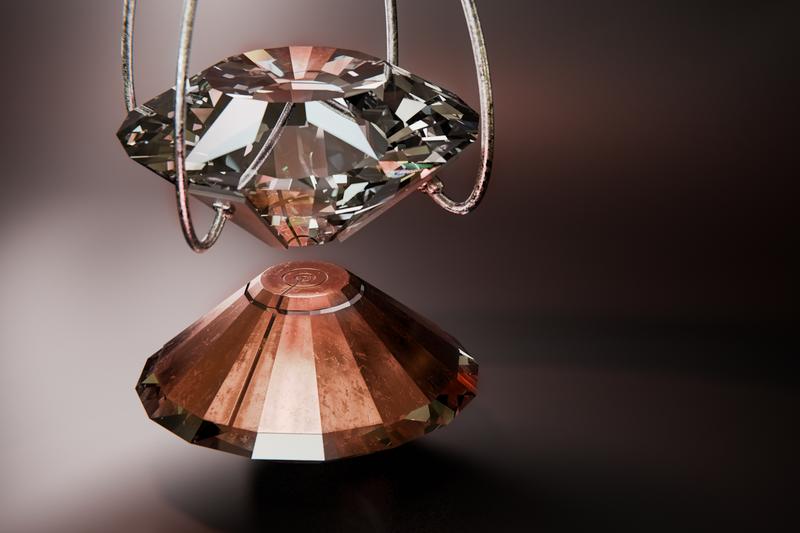 Artistic representation of the interior of a diamond anvil cell. A copper-colored, multi-stage Lenz lens is placed on the lower diamond anvil, while electrical contacts for resistance measurements are attached to the upper diamond anvil.
