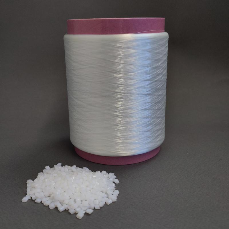 TPC granules with a spool of yarn