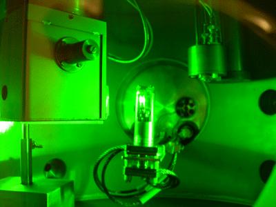 The photograph shows an experiment in which dense deuterium is irradiated by a laser. The white glow in the container in the centre of the photograph is from deuterium.